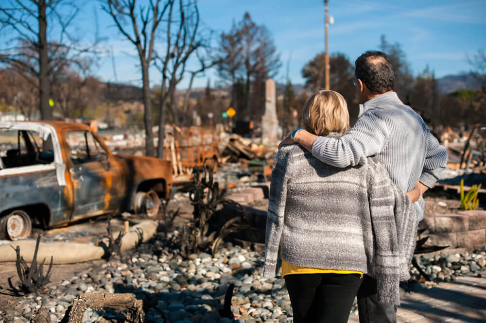 Couple Looks On After Home Fire