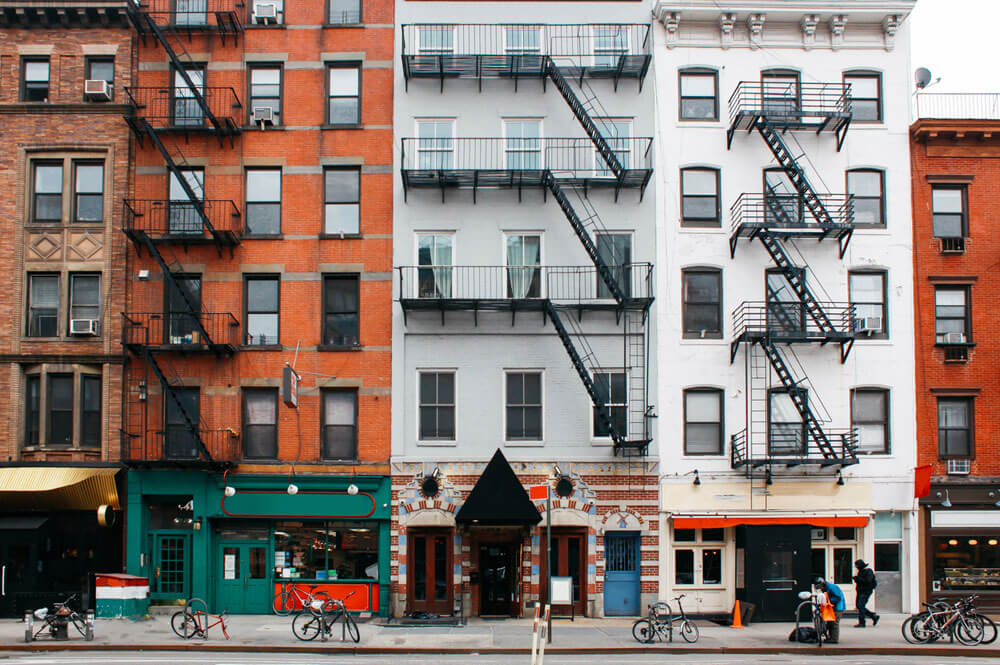 Line of mixed-use buildings with shops at street level and apartments above